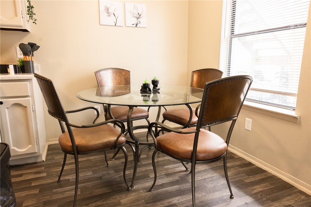 800 Navidad Street Bryan, TX 77801 - Photo 12 of 42 Dining space with dark wood-style flooring and baseboards