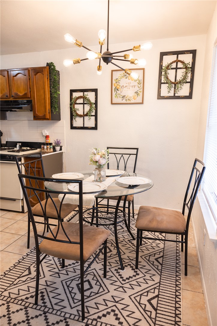800 Navidad Street Bryan, TX 77801 - Photo 23 of 42 a view of a dining room with furniture and a kitchen