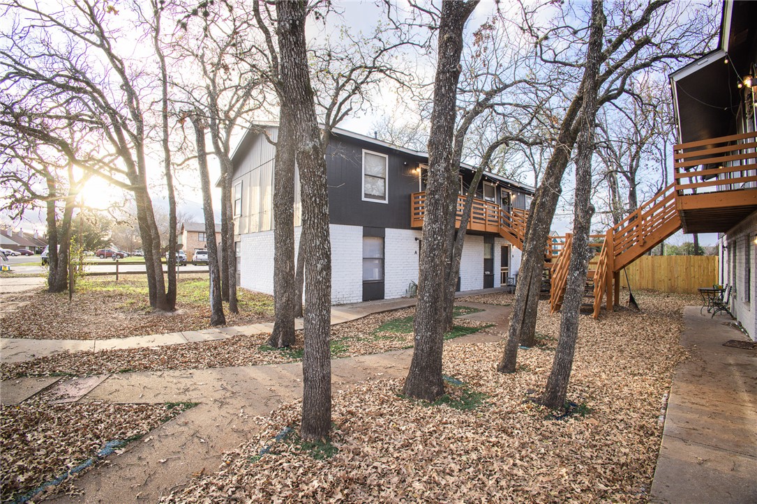 800 Navidad Street Bryan, TX 77801 - Photo 3 of 42 View of property exterior featuring stairs and brick siding
