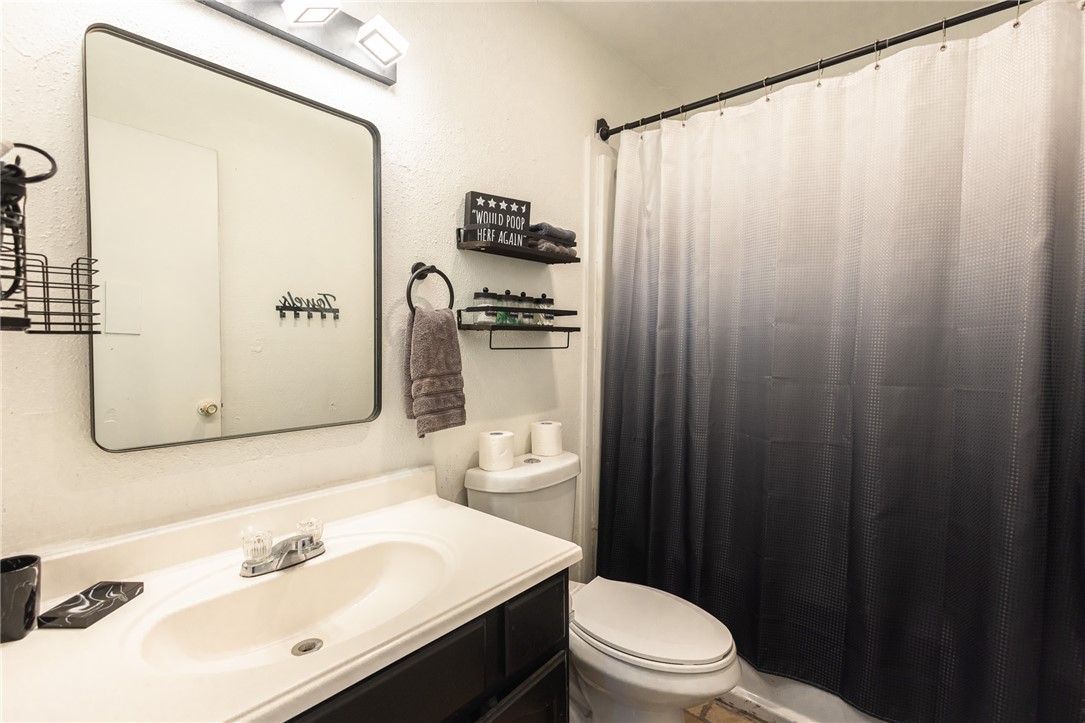 800 Navidad Street Bryan, TX 77801 - Photo 32 of 42 Bathroom featuring vanity and curtained shower