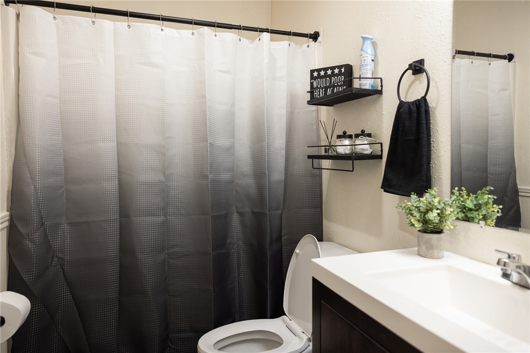 800 Navidad Street Bryan, TX 77801 - Photo 9 of 42 Bathroom featuring vanity and a shower with curtain