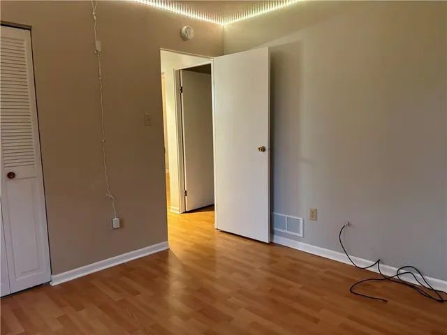 a view of a room with wooden floor and closet