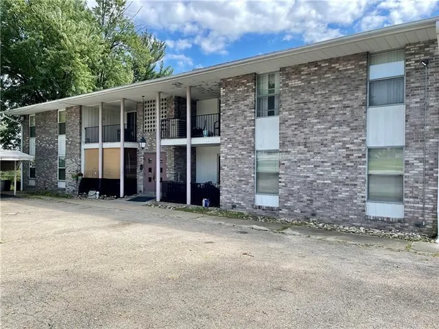 a view of a house with a yard and garage