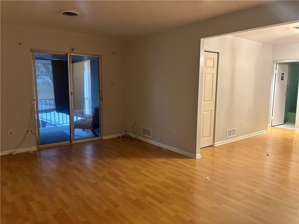 105 Pittsburgh Street, Unit 2C Uniontown, PA 15401 - Photo 10 of 21 a view of an empty room with wooden floor and a window