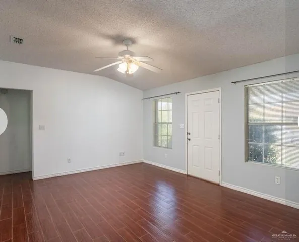 a kitchen with a refrigerator and a stove top oven