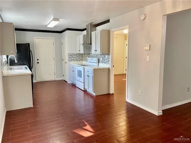 a kitchen with a sink stove and refrigerator