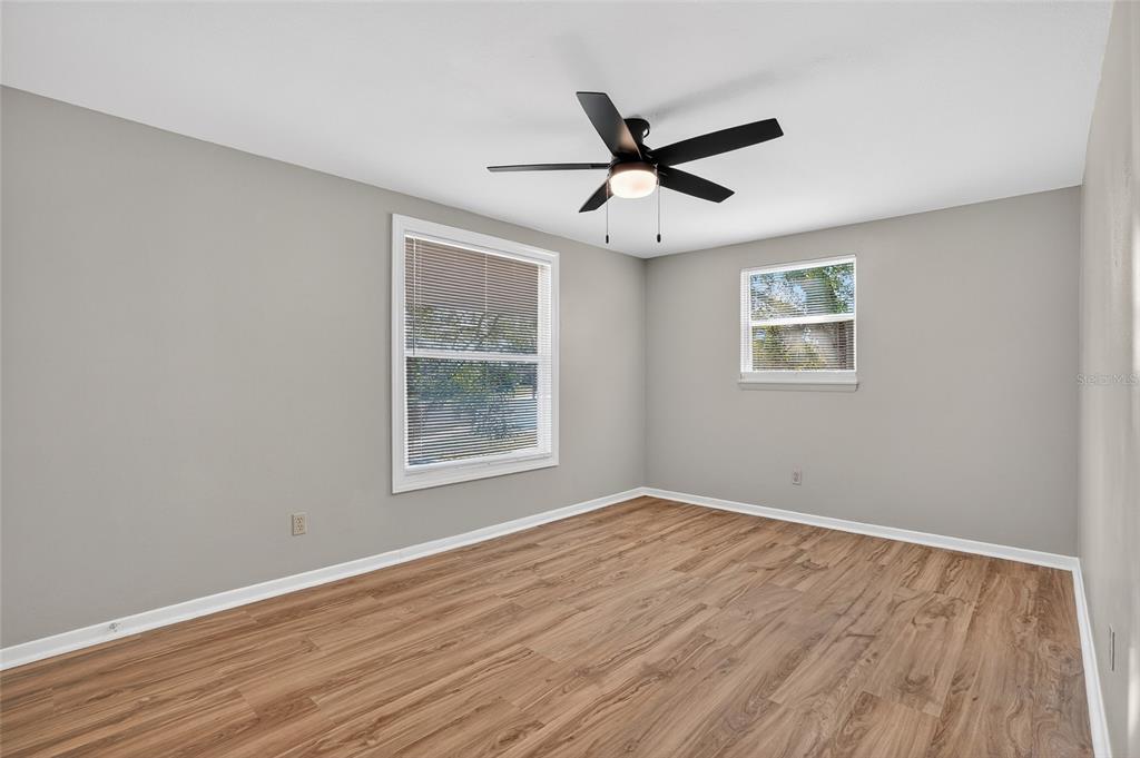 8244 125th Street Seminole, FL 33776 - Photo 14 of 32 a view of an empty room with wooden floor and a window