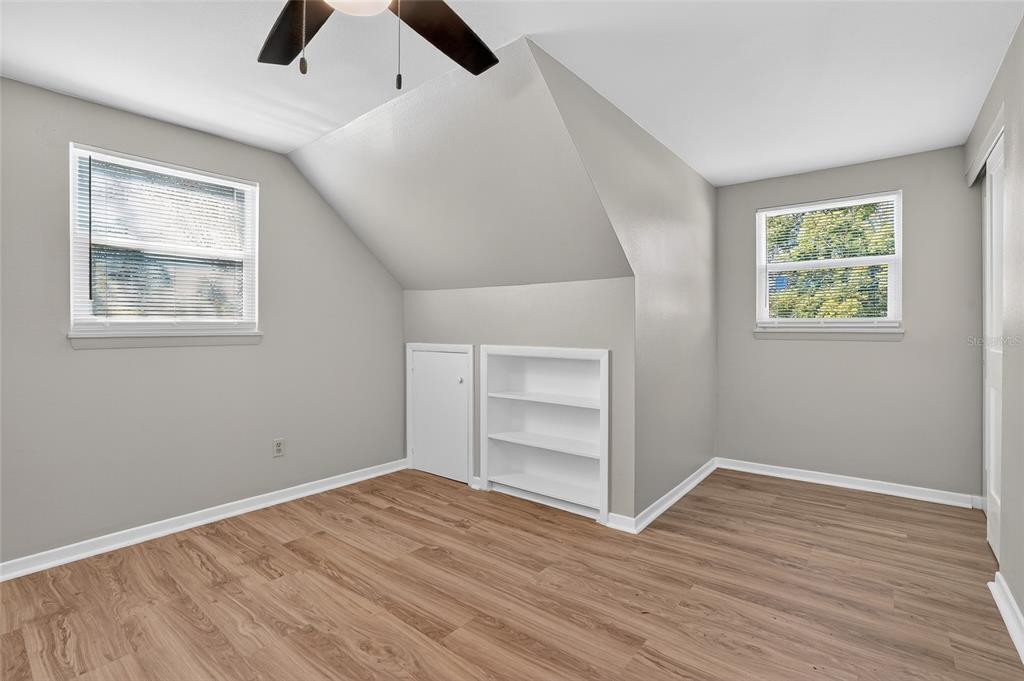8244 125th Street Seminole, FL 33776 - Photo 16 of 32 wooden floor in an empty room with a window
