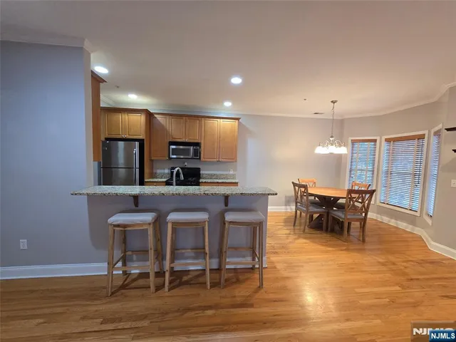a kitchen with wooden floors and wooden cabinets