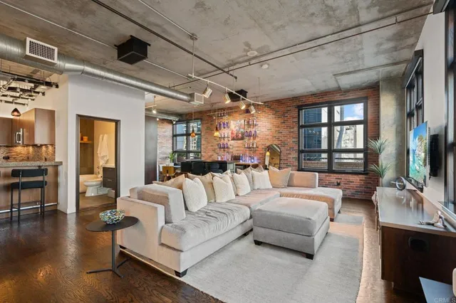 a bedroom with a large bed and windows