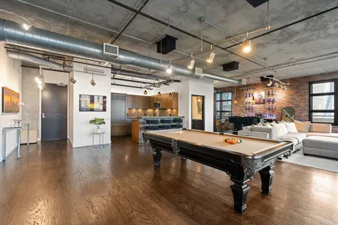 a dining room with furniture and a floor to ceiling window