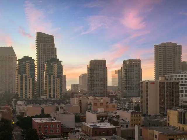a dining room with furniture a chandelier and wooden floor