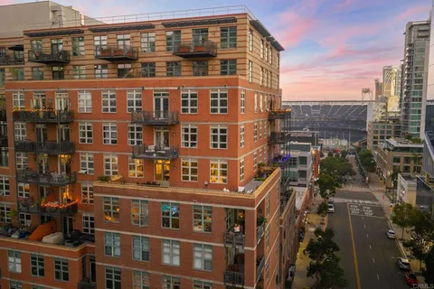 a living room with furniture a floor to ceiling window and a flat screen tv