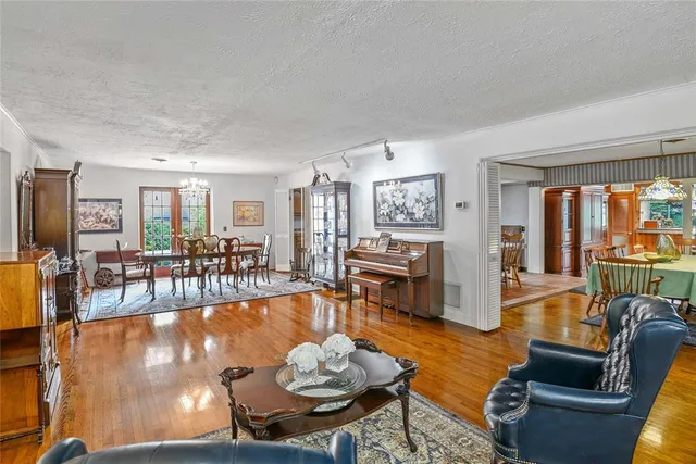 a living room with fireplace furniture and a table