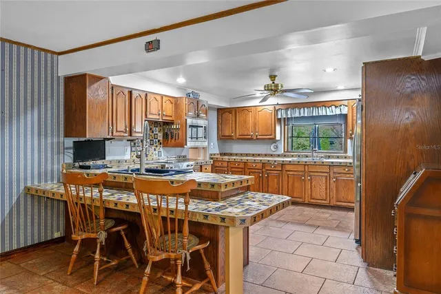a view of a kitchen with granite countertop a sink and a counter top space
