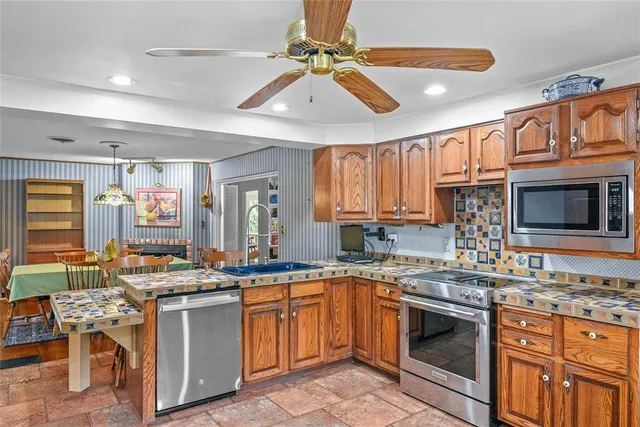 a kitchen with stainless steel appliances granite countertop a stove sink and cabinets