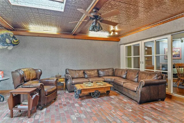 a living room with furniture a rug and a window