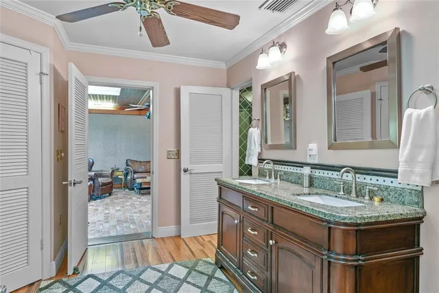 a spacious bathroom with a granite countertop sink a mirror and shower