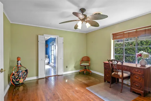 a workspace with wooden floor and a window