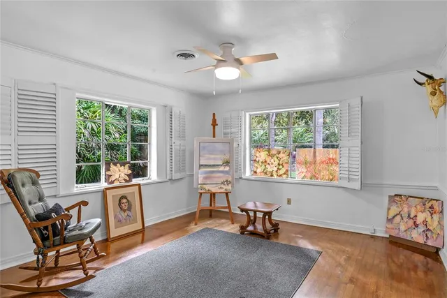 a view of a porch with chairs and backyard