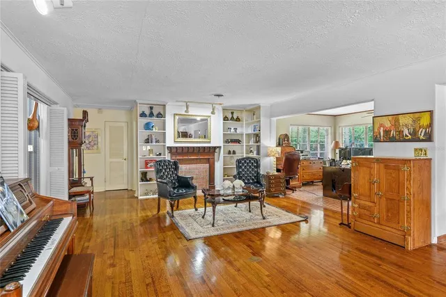 a living room with furniture pool view and large windows