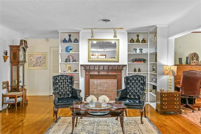 a living room with furniture fireplace and rug
