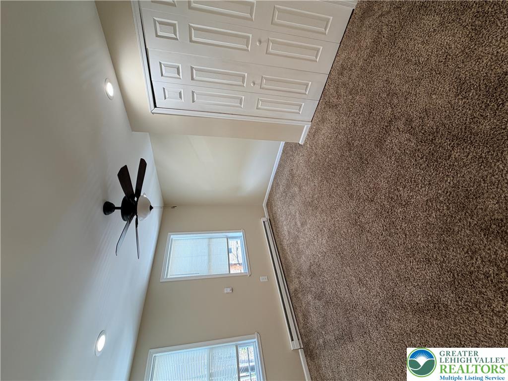 718 Ferry Street Easton, PA 18042 - Photo 19 of 37 Plush carpeting and a classic ceiling fan elevate this restful bedroom retreat.