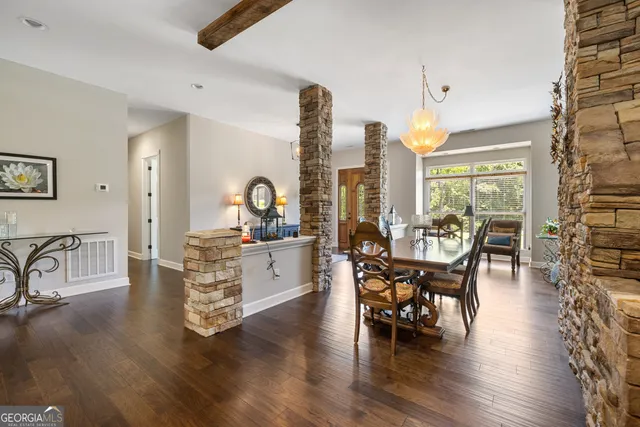 a view of a kitchen with fridge and wooden floor