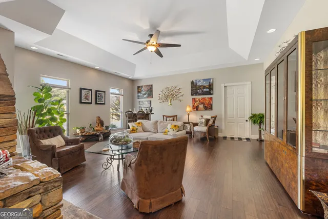 a living room with furniture a wooden floor and a chandelier
