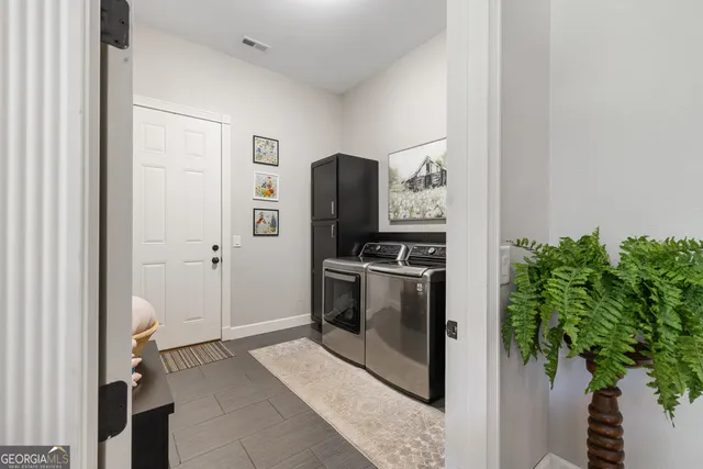 a large kitchen with stainless steel appliances a stove refrigerator and cabinets