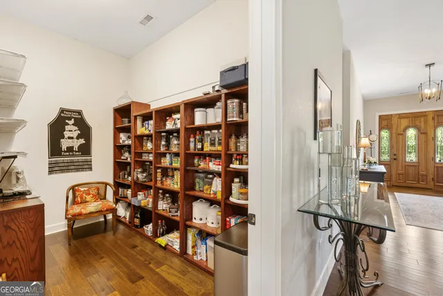 a bedroom with furniture and a large window