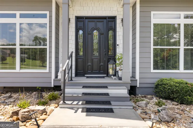 a hallway with a large window and wooden floor
