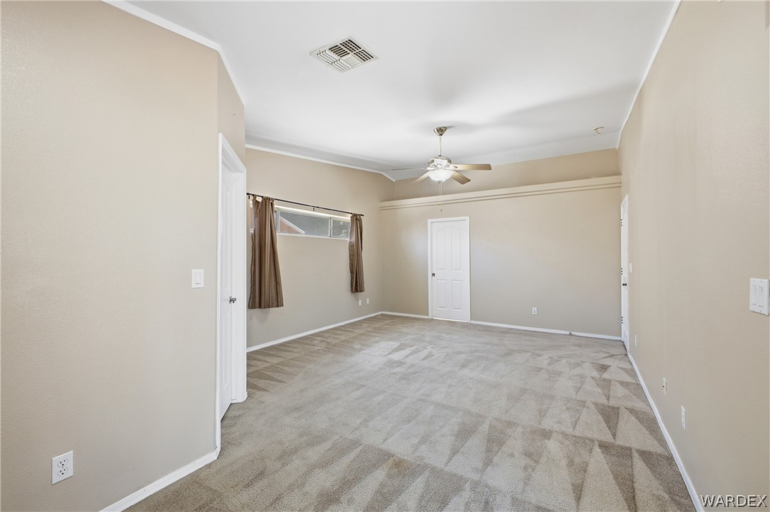 3918 North Eagle Rock Road Kingman, AZ 86409 - Photo 25 of 44 an empty room with windows and closet