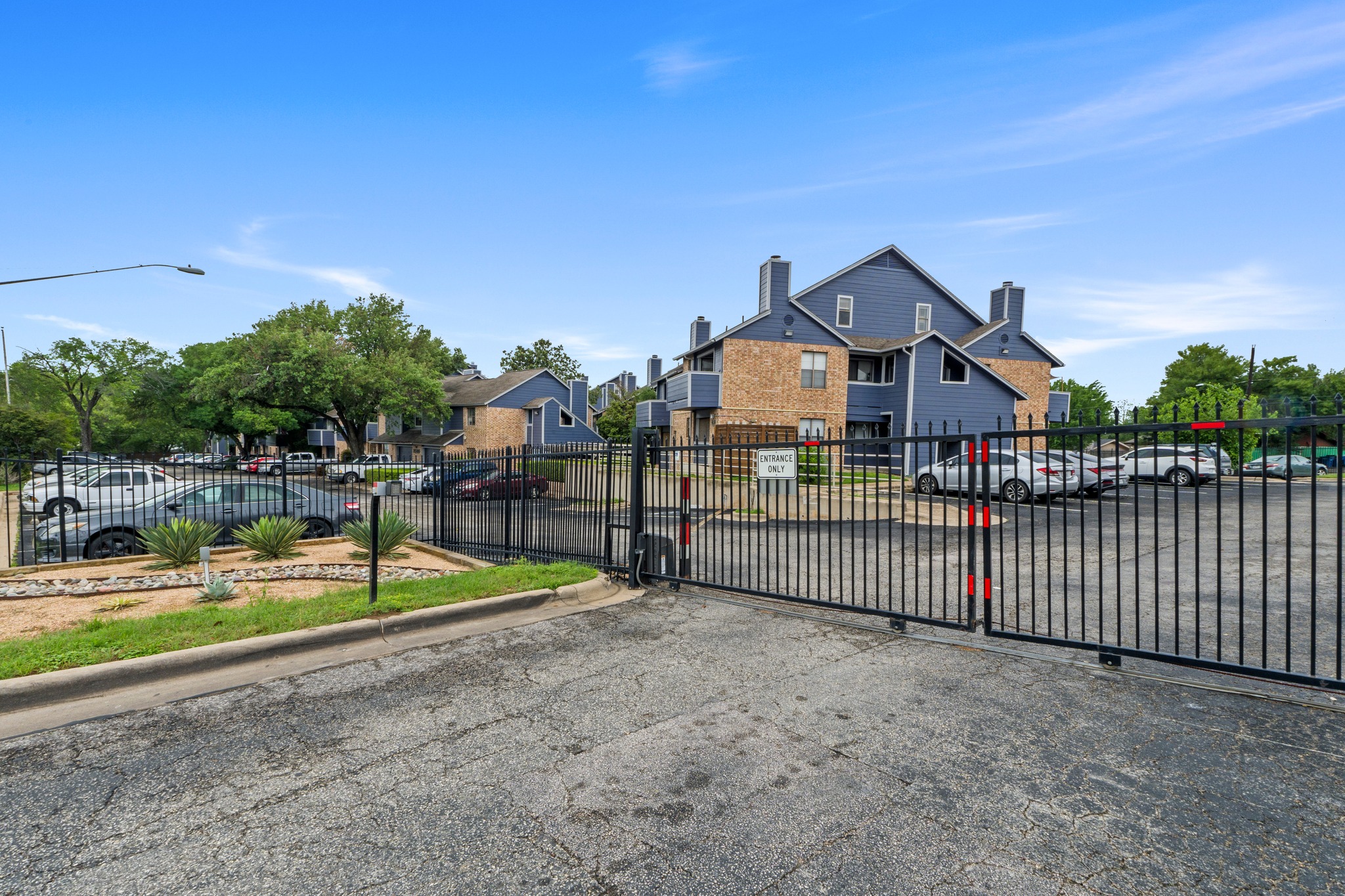 2500 Burleson Road, Unit 713 Austin, TX 78741 - Photo 13 of 15 Secure gated entry welcomes you to this thoughtfully designed community, boasting ample parking and mature landscaping.