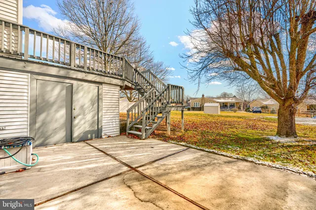a view of a white house with a yard covered with snow