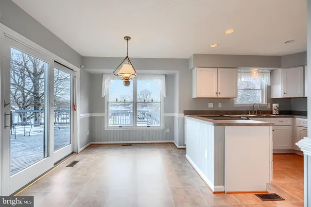 a kitchen with refrigerator and window