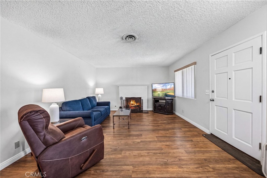 29078 Bradley Road Menifee, CA 92586 - Photo 10 of 42 a living room with furniture and a fireplace