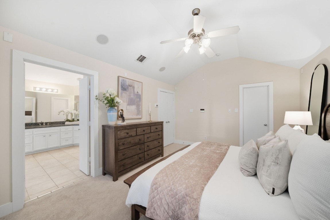 5817 Darling Street, Unit D Houston, TX 77007 - Photo 26 of 40 a bedroom with a large bed and a chandelier