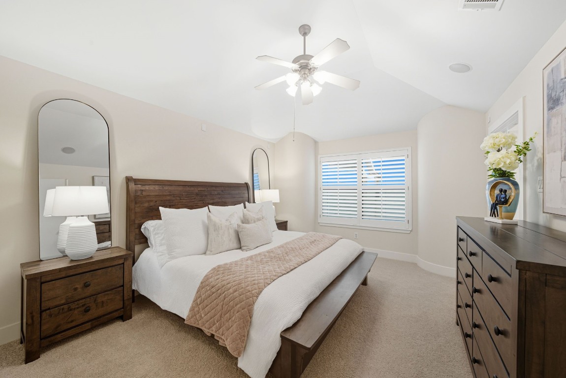 5817 Darling Street, Unit D Houston, TX 77007 - Photo 5 of 40 a bedroom with a bed and a chandelier