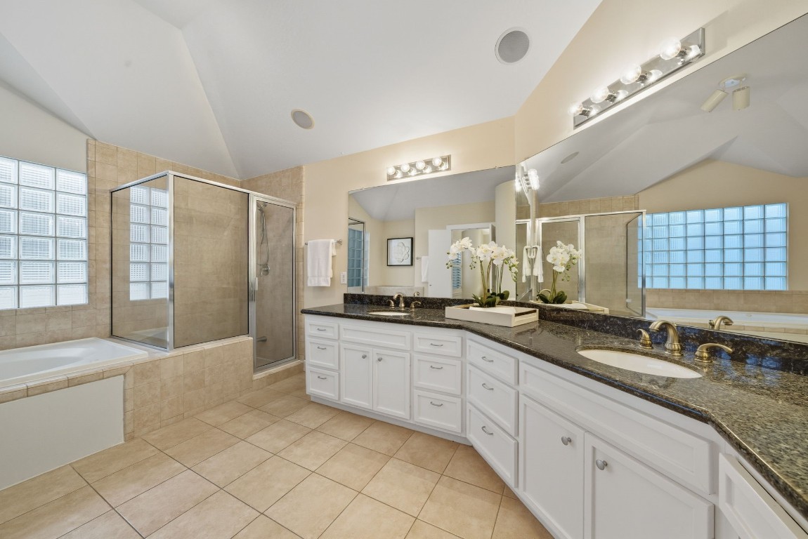 5817 Darling Street, Unit D Houston, TX 77007 - Photo 6 of 40 a large bathroom with a granite countertop double vanity sink a mirror and a bathtub