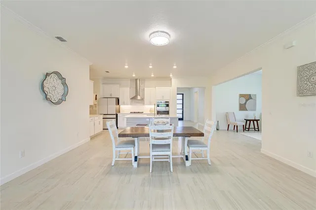 a view of a livingroom with wooden floor and a ceiling fan