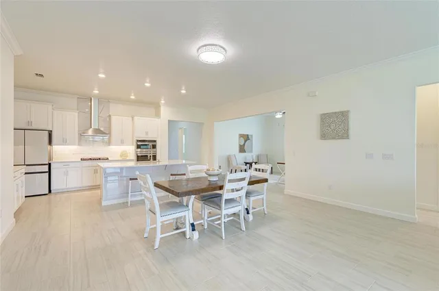 a bathroom with a double vanity sink a toilet and a large mirror