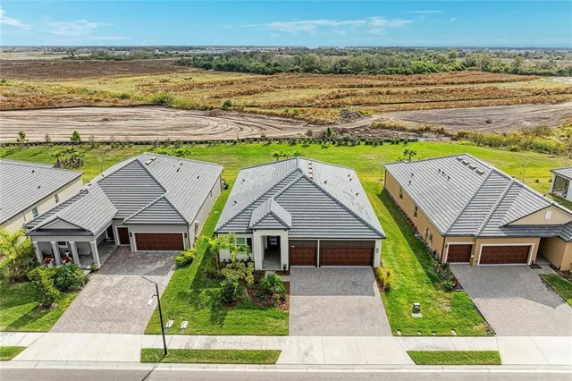 an aerial view of a house with a swimming pool yard and outdoor seating