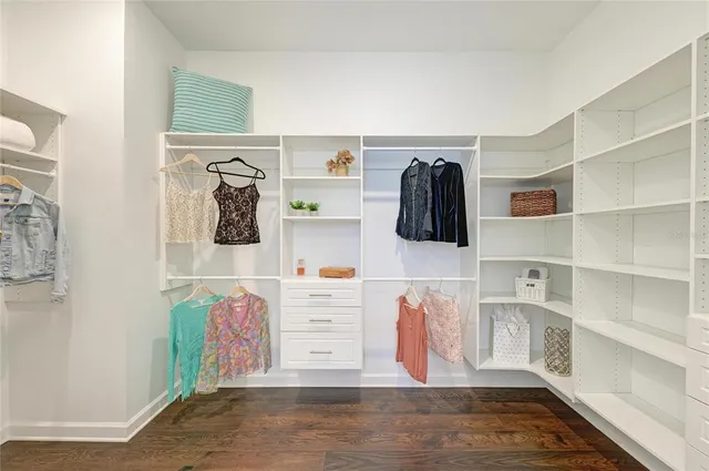 a view of a backyard with table and chairs and potted plants
