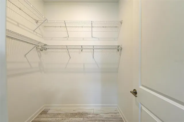 a view of a house with a yard and potted plants