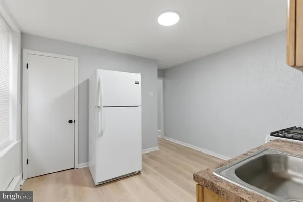 a white toilet sitting next to a bath tub