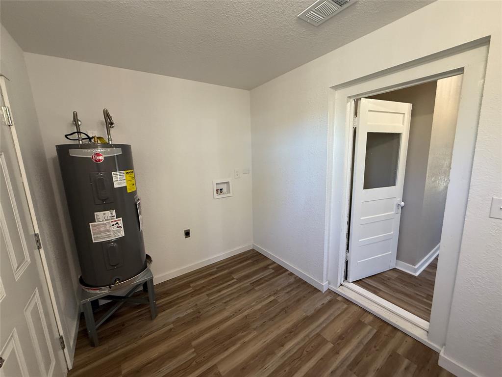 705 East 9th Street Coleman, TX 76834 - Photo 14 of 29 a view of a room with gym equipment and wooden floor