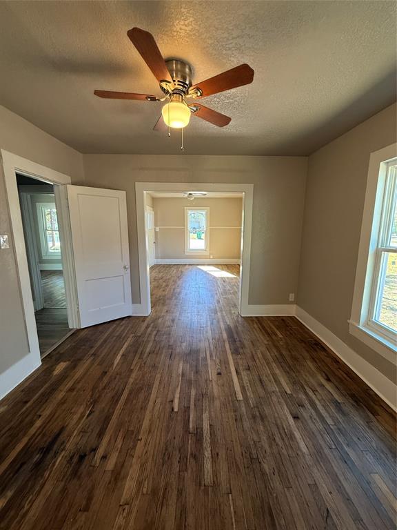 705 East 9th Street Coleman, TX 76834 - Photo 18 of 29 wooden floor in an empty room with a window