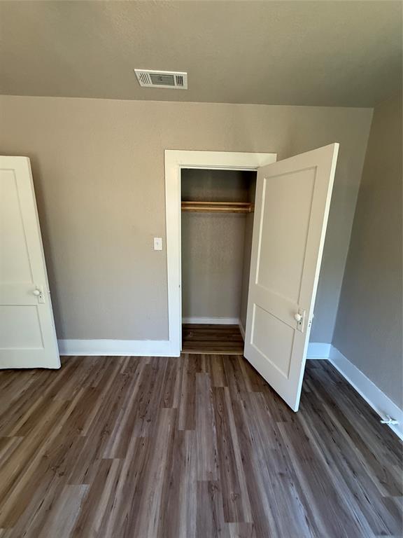 705 East 9th Street Coleman, TX 76834 - Photo 24 of 29 a view of an empty room with wooden floor and a window