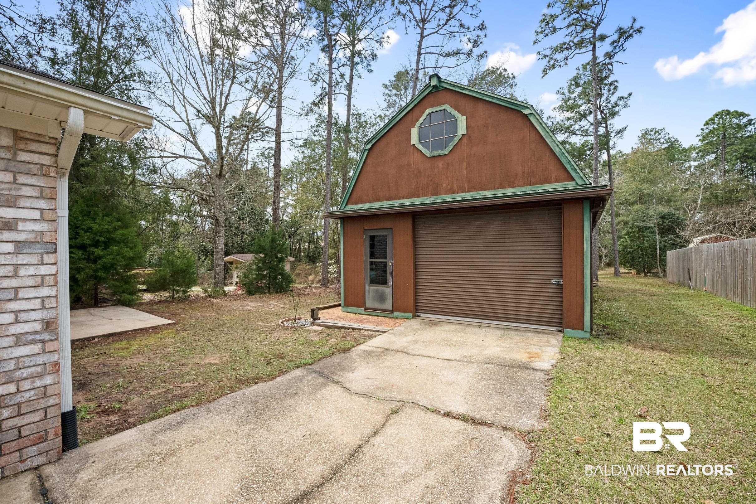 2673 Pine Ridge Drive Lillian, AL 36549 - Photo 26 of 38 View of outbuilding with an outbuilding, fence, and driveway